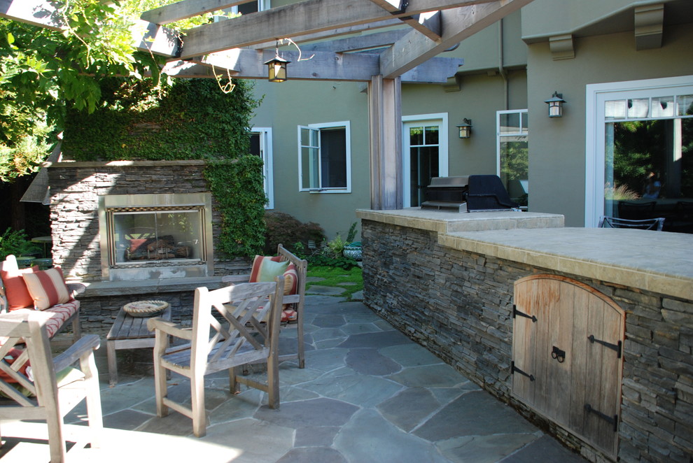 Example of a classic patio design in San Francisco with a fire pit and a pergola