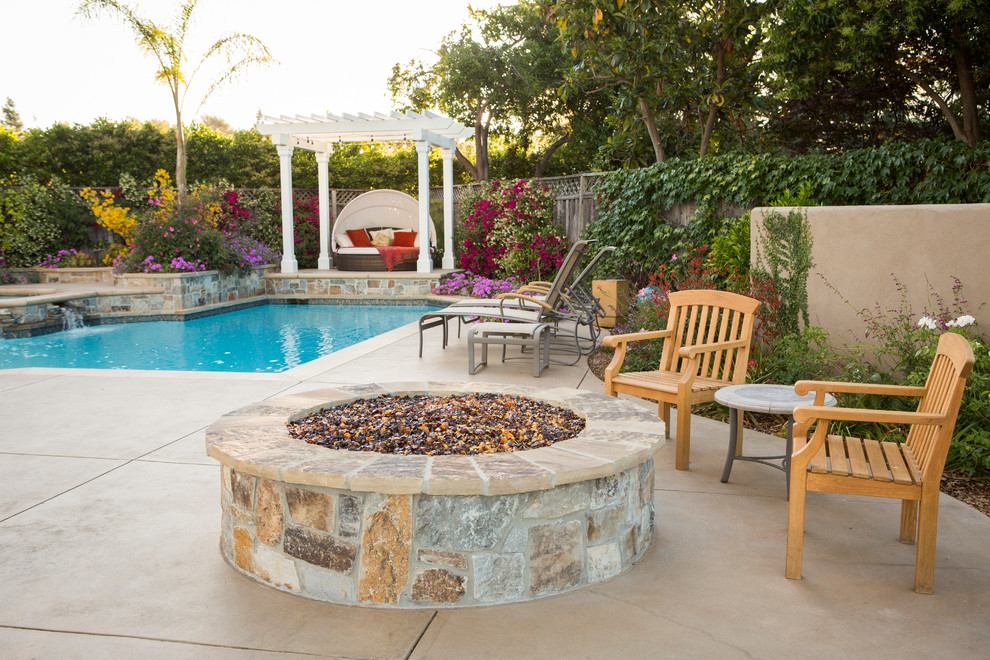 Large classic back patio in San Francisco with a pergola and natural stone paving.