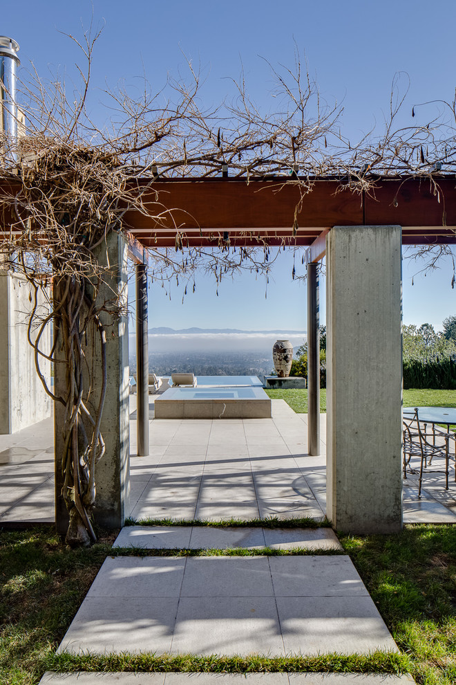 Inspiration for a large contemporary side patio in San Francisco with concrete paving and a pergola.
