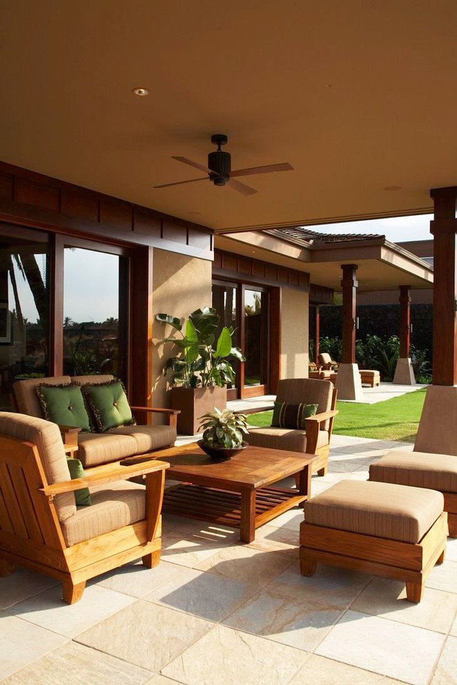 This is an example of a world-inspired patio in Hawaii with a roof extension.