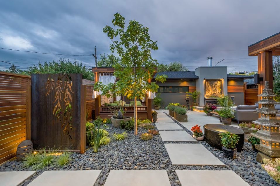 Photo of a medium sized world-inspired back patio in Calgary with a gazebo.