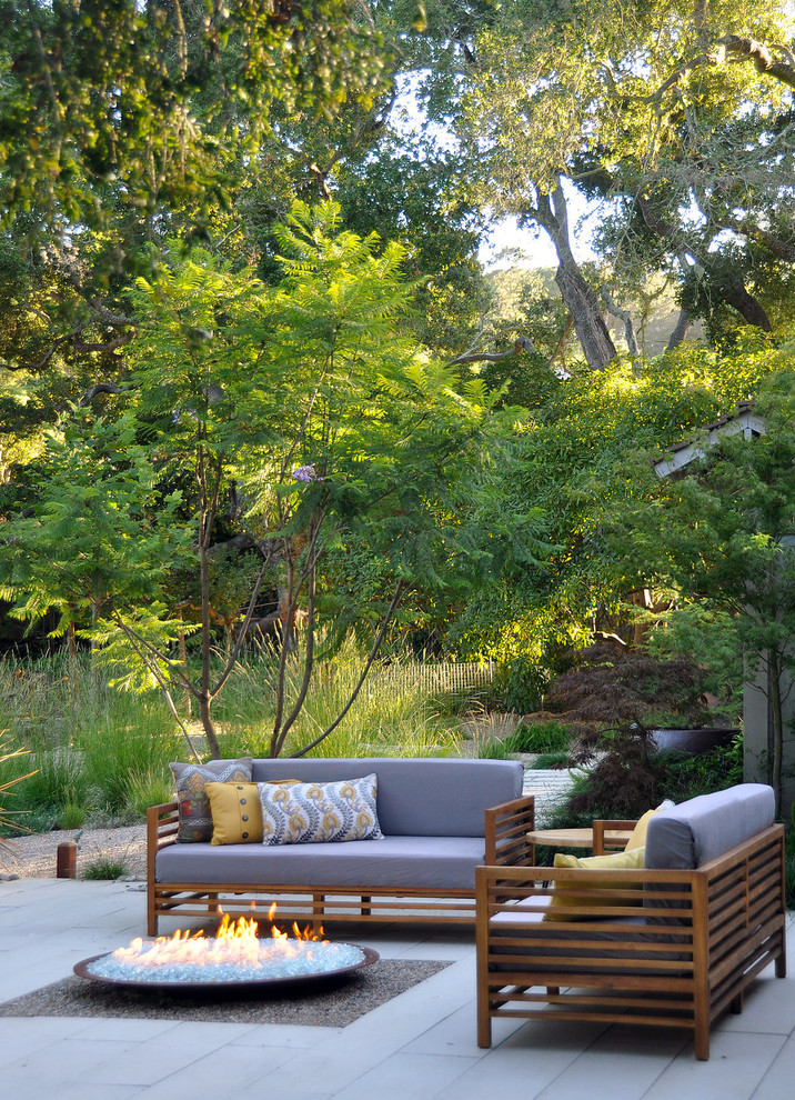 Design ideas for an expansive rural back patio in Santa Barbara with concrete paving, a fire feature and no cover.