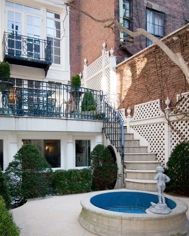Inspiration for a timeless backyard tile patio fountain remodel in Boston