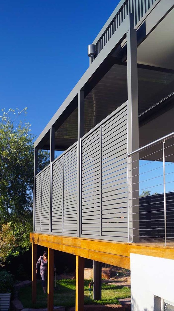 Idées déco pour une terrasse en bois latérale moderne de taille moyenne avec une extension de toiture et une cuisine d'été.