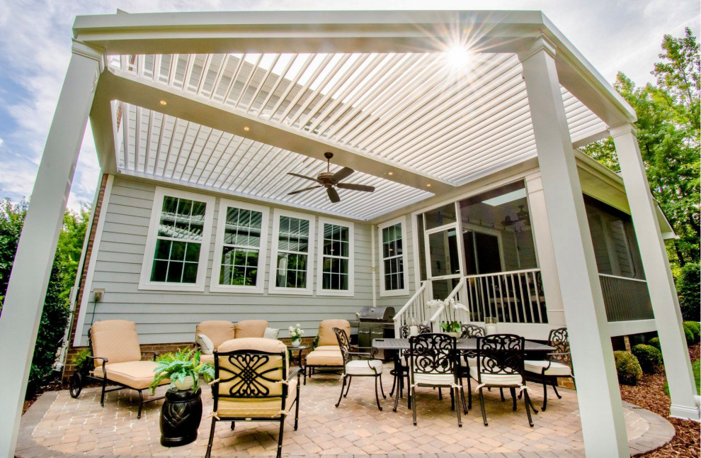 Photo of a small contemporary back patio with a pergola.