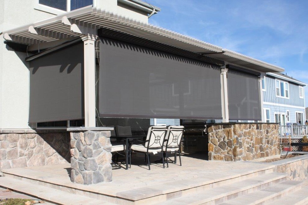 Inspiration for a medium sized traditional back patio in Louisville with natural stone paving and a pergola.