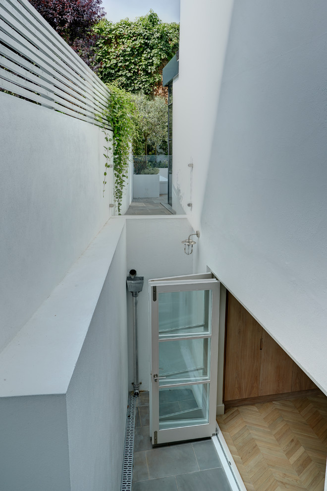 Inspiration for a small classic courtyard patio in London with an outdoor shower, natural stone paving and no cover.