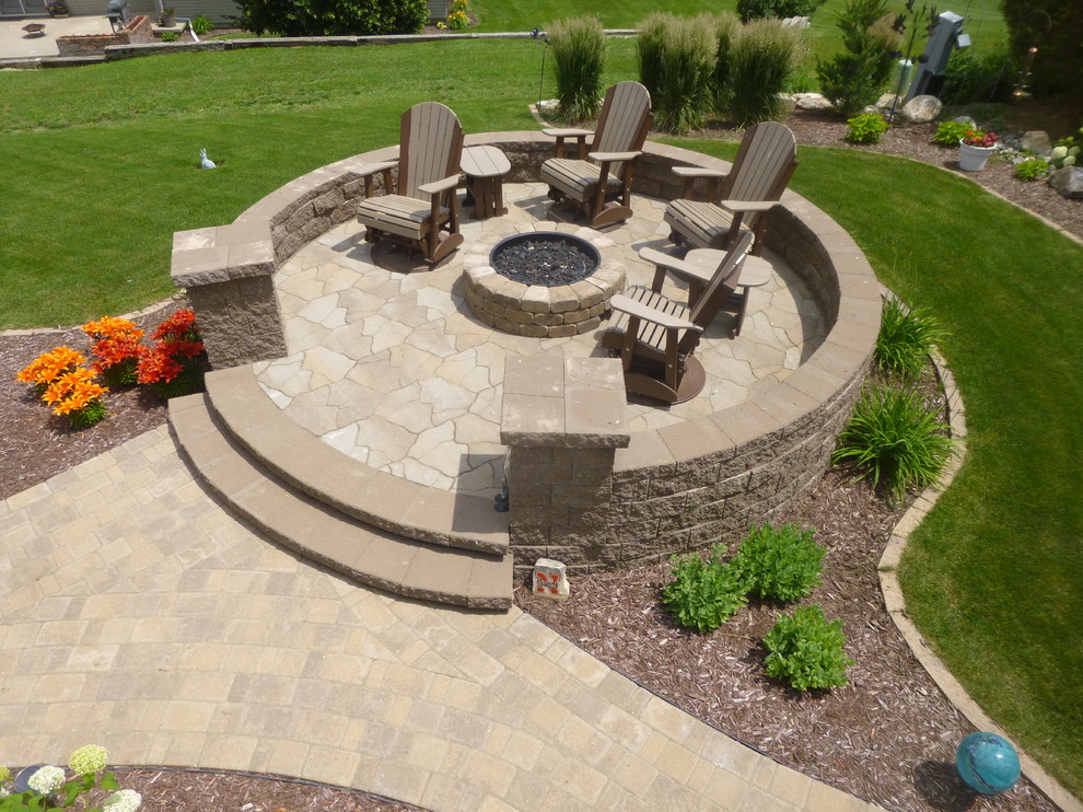 Design ideas for a large traditional back patio in Other with a fire feature, natural stone paving and no cover.