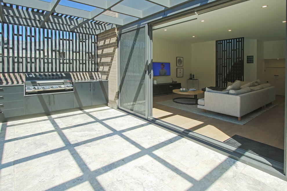 Inspiration for a contemporary back patio in Canberra - Queanbeyan with tiled flooring and a pergola.