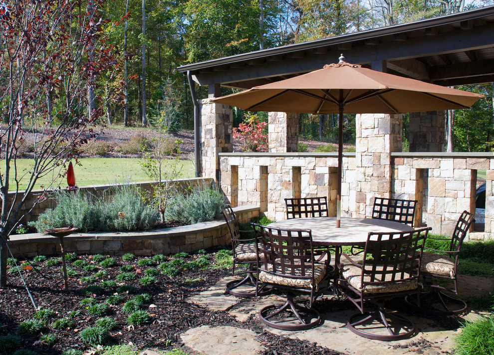 Inspiration for a large classic back patio in Atlanta with an outdoor kitchen, natural stone paving and a gazebo.
