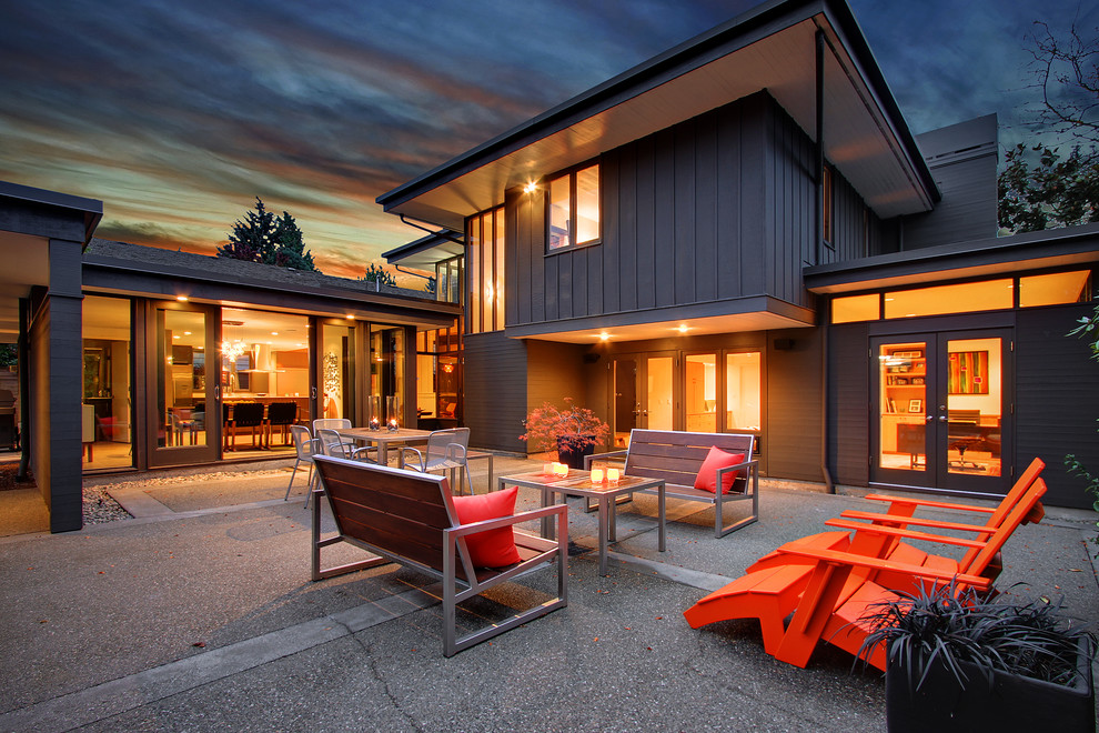 Photo of a medium sized midcentury courtyard patio in Seattle with concrete slabs and no cover.