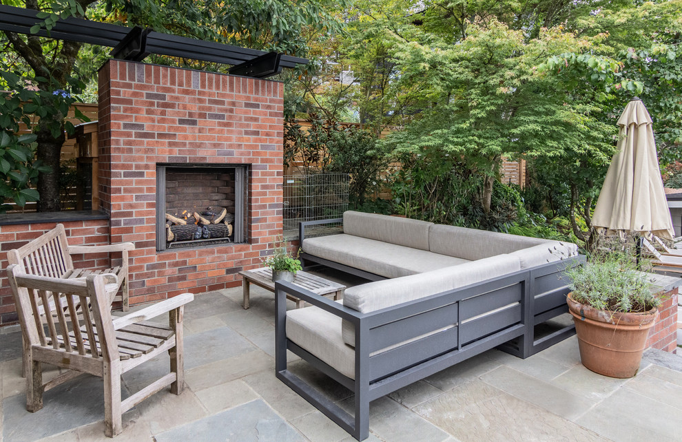 Inspiration for a transitional backyard tile patio remodel in Seattle with a fireplace