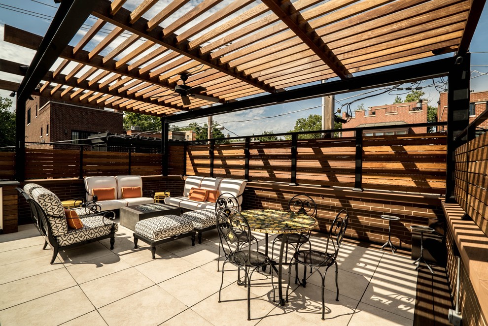 Photo of a medium sized contemporary back patio in Orange County with a fire feature, tiled flooring and a pergola.