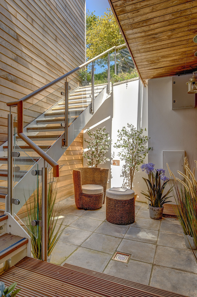 Foto di un patio o portico design in cortile con un tetto a sbalzo e scale