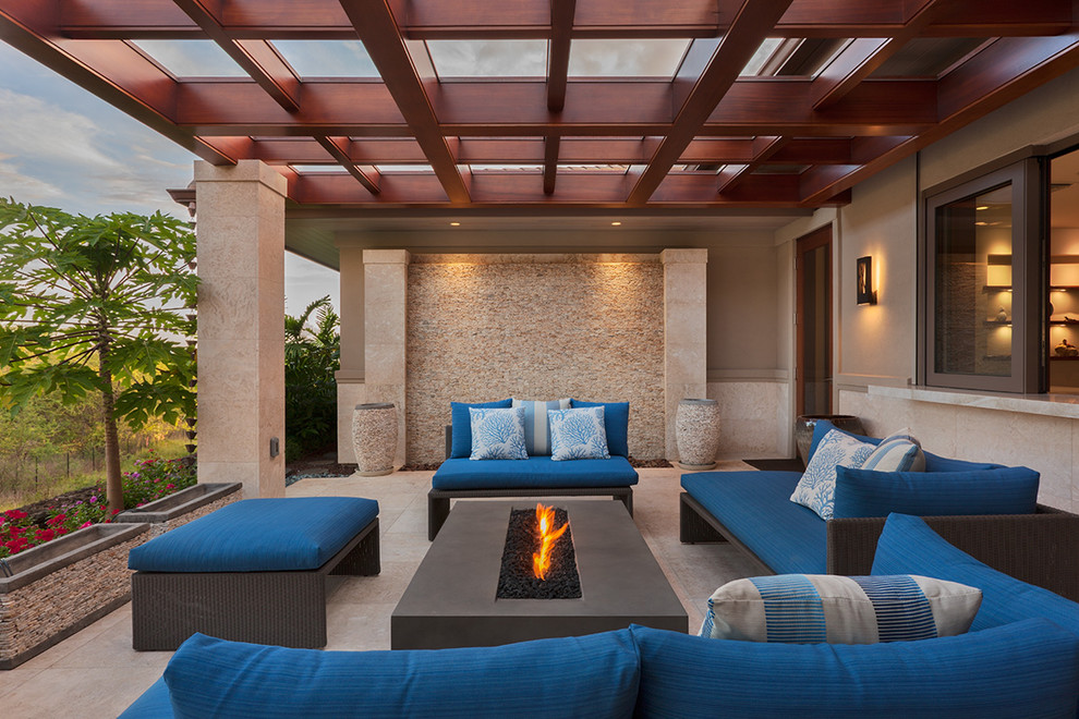 Inspiration for a nautical patio in Hawaii with a fire feature, tiled flooring and a pergola.