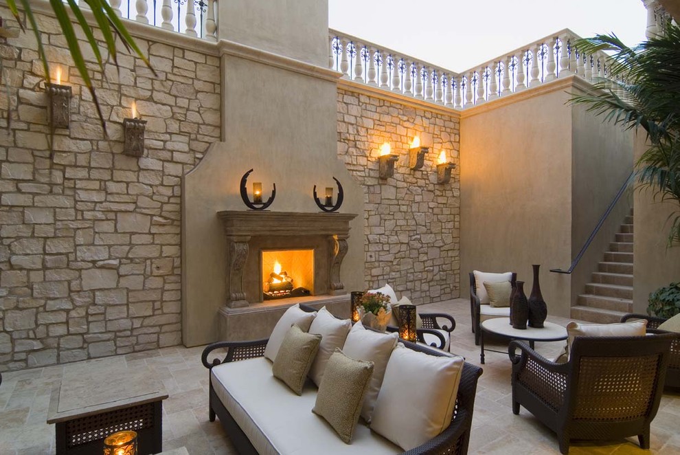 Design ideas for a mediterranean patio in Orange County with a fire feature and no cover.
