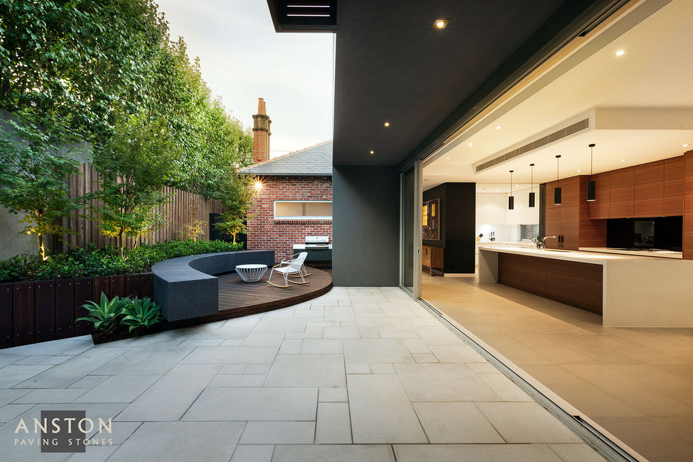 Inspiration for a modern side yard concrete paver patio remodel in Melbourne with a pergola