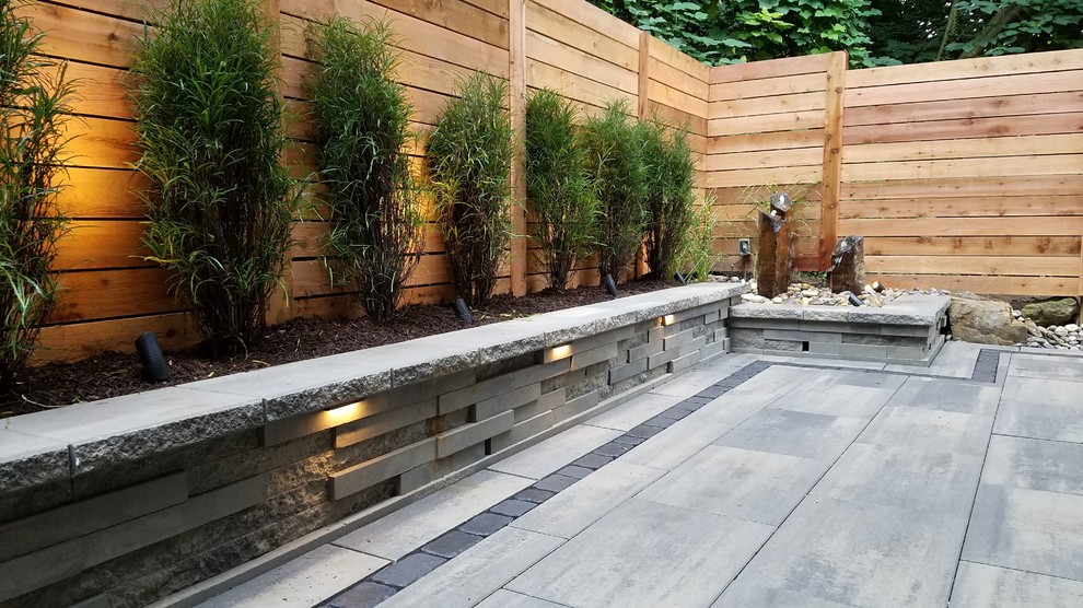 Inspiration for a mid-sized modern backyard tile patio remodel in Philadelphia with no cover