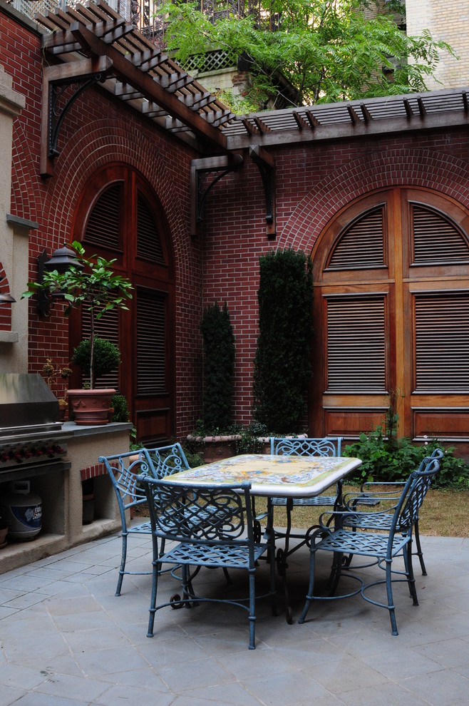 This is an example of a classic courtyard patio in New York with no cover and a bbq area.