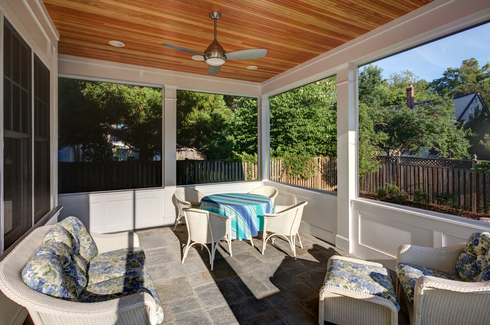 Medium sized traditional back patio in DC Metro with tiled flooring and a roof extension.