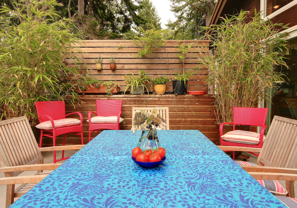This is an example of a medium sized rustic back patio in Portland with no cover.