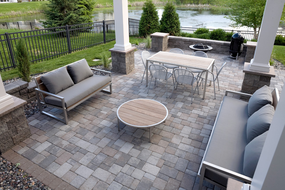 Inspiration for a medium sized classic back patio in Minneapolis with concrete paving, a fire feature and a pergola.