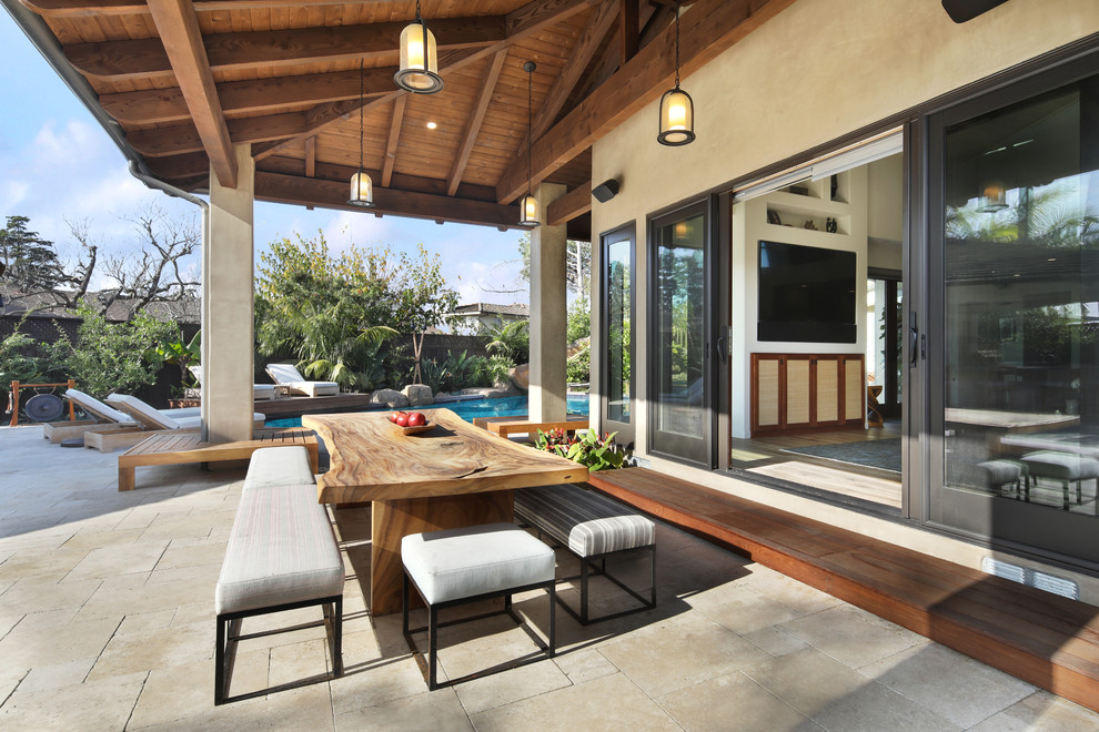 Patio - coastal backyard patio idea in Orange County with a roof extension