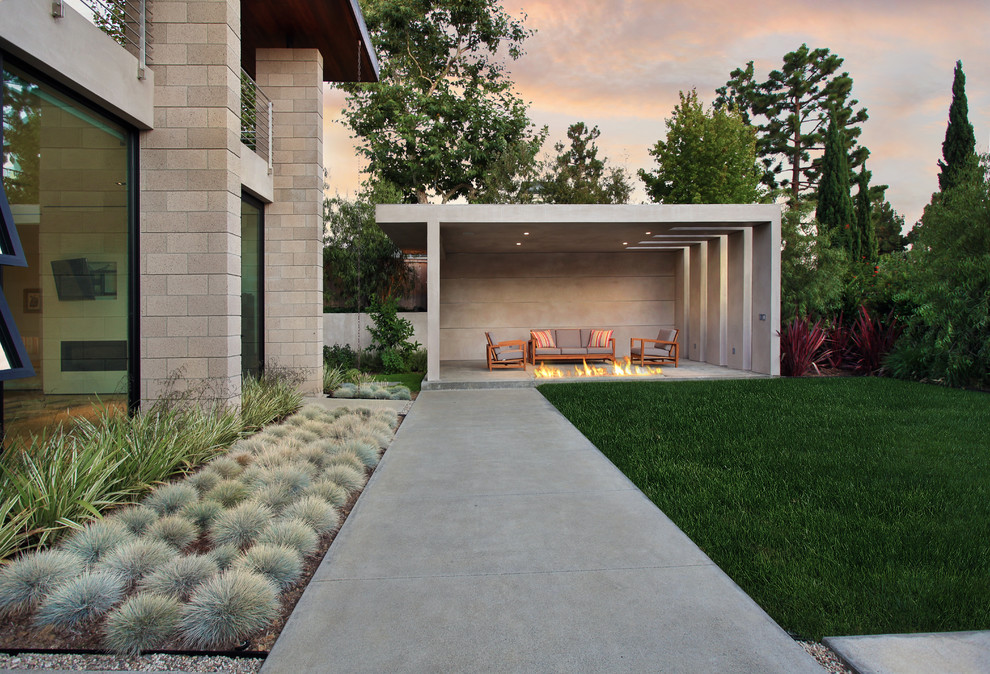 Inspiration for a contemporary patio remodel in Orange County with a fire pit