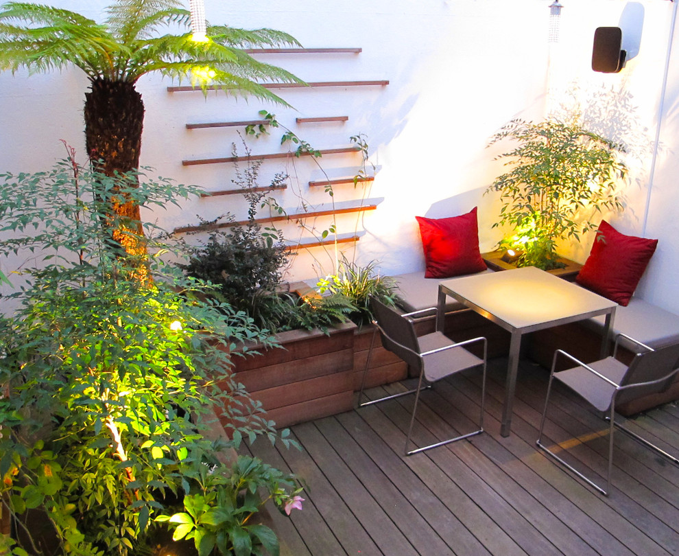 Design ideas for a small contemporary courtyard patio in London with a potted garden and decking.
