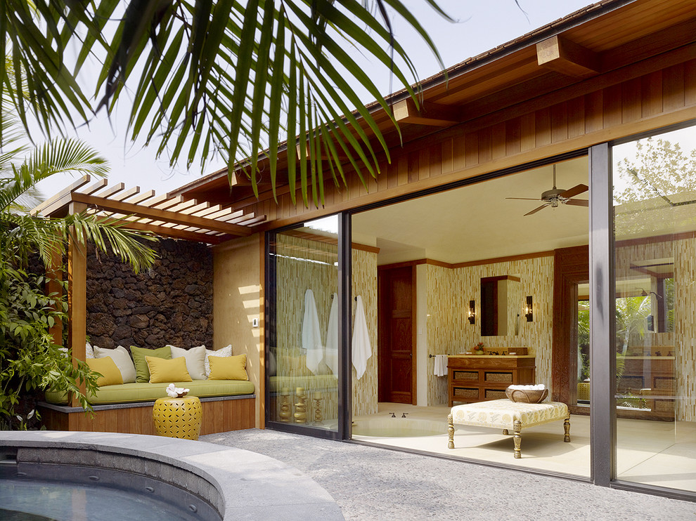 Inspiration for a world-inspired courtyard patio in Hawaii with a pergola.