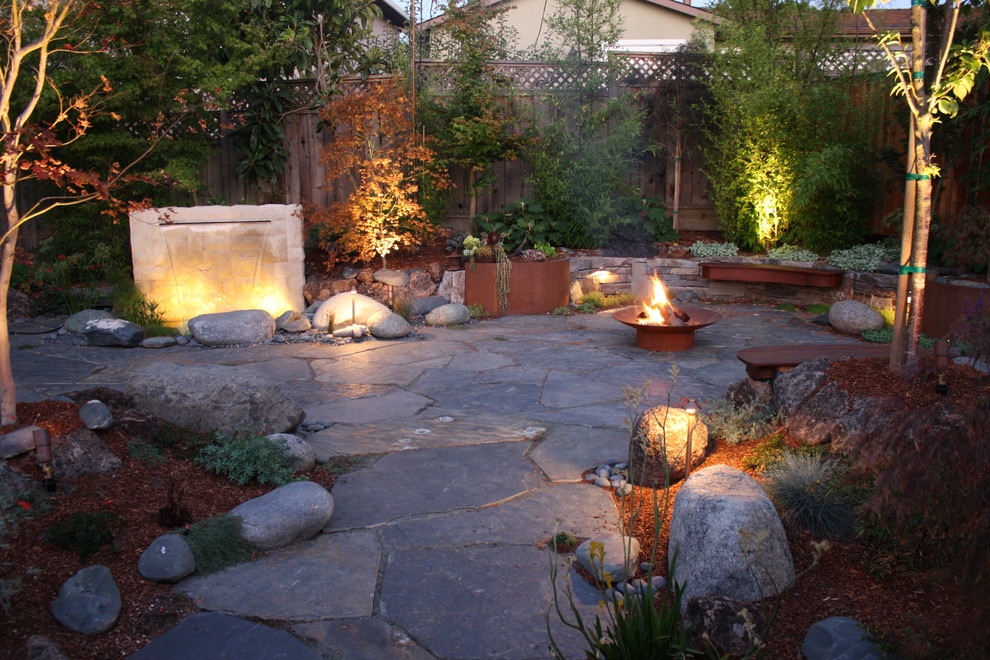 Inspiration for a world-inspired back patio in San Francisco with a fire feature.