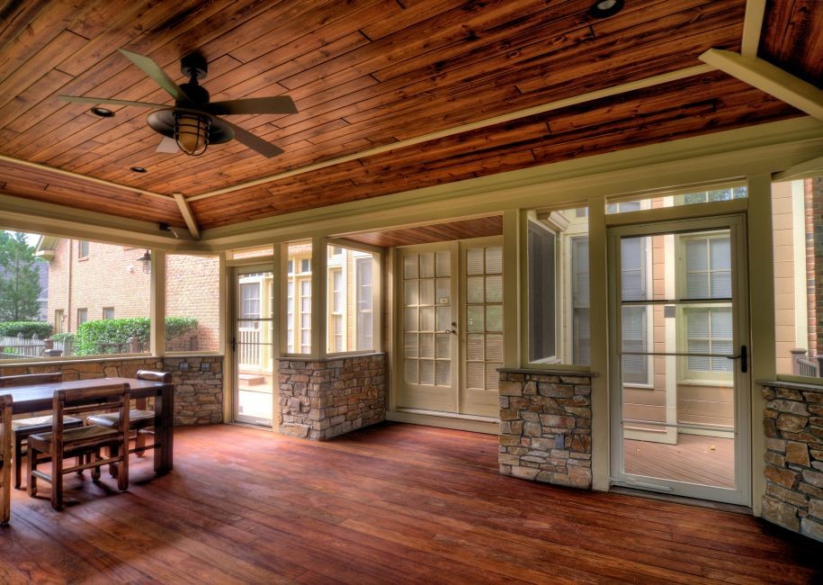 This is an example of an expansive rustic back patio in DC Metro with decking and a roof extension.