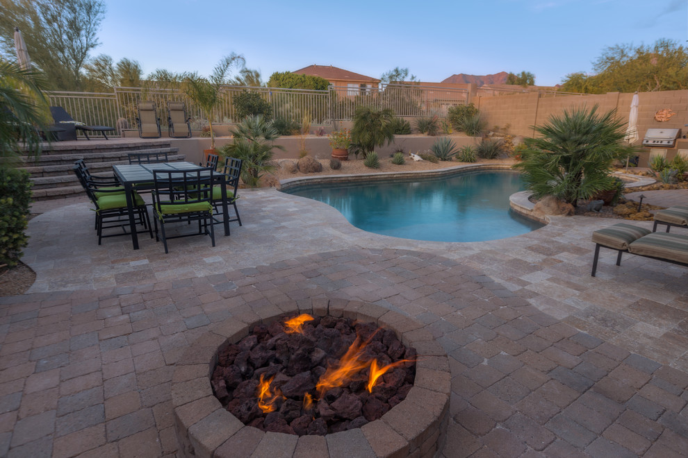 Design ideas for a medium sized mediterranean back patio in Phoenix with a fire feature, concrete paving and no cover.