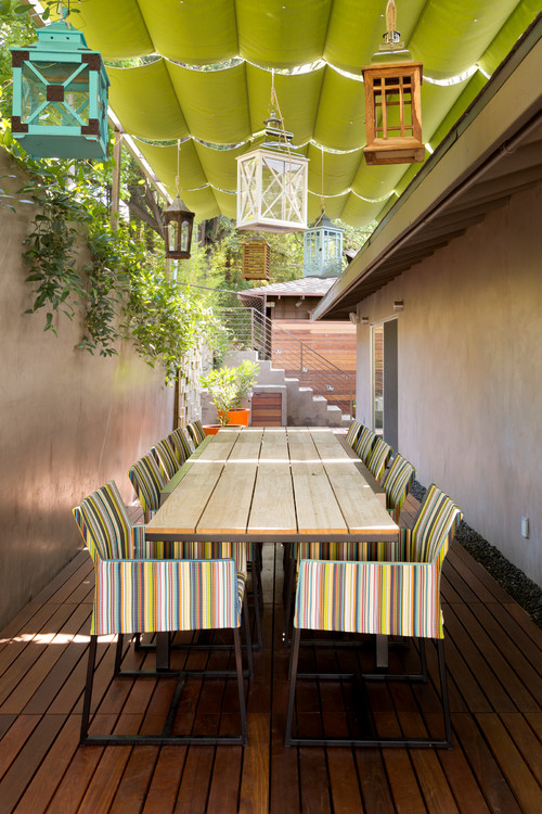 contemporary cool patio with large table and lanterns