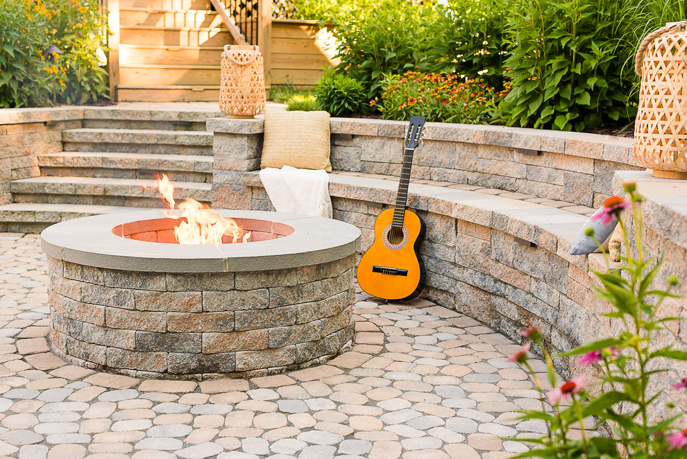 Medium sized traditional back patio in Richmond with a fire feature and concrete paving.