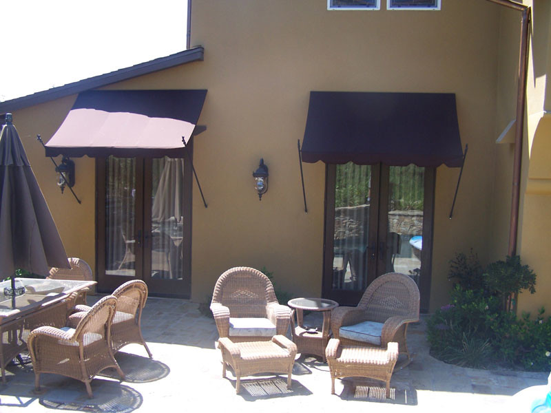 Inspiration for a small mediterranean back patio in Orange County with an awning.
