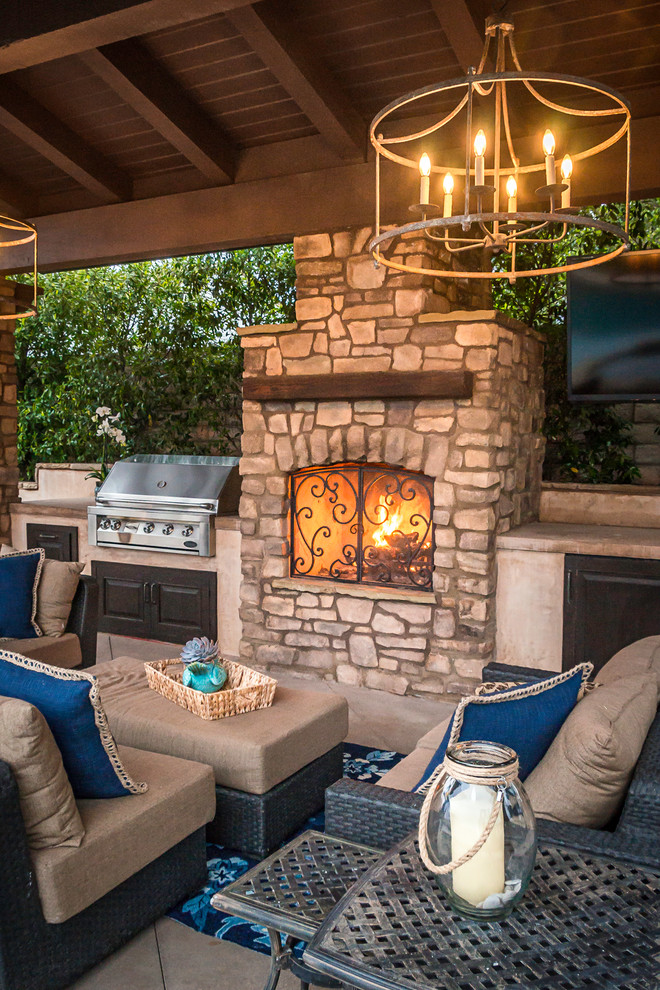 Inspiration for a medium sized mediterranean back patio in Los Angeles with a fire feature and a gazebo.
