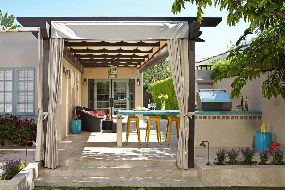 Mediterranean patio in Los Angeles with a fire feature and a pergola.