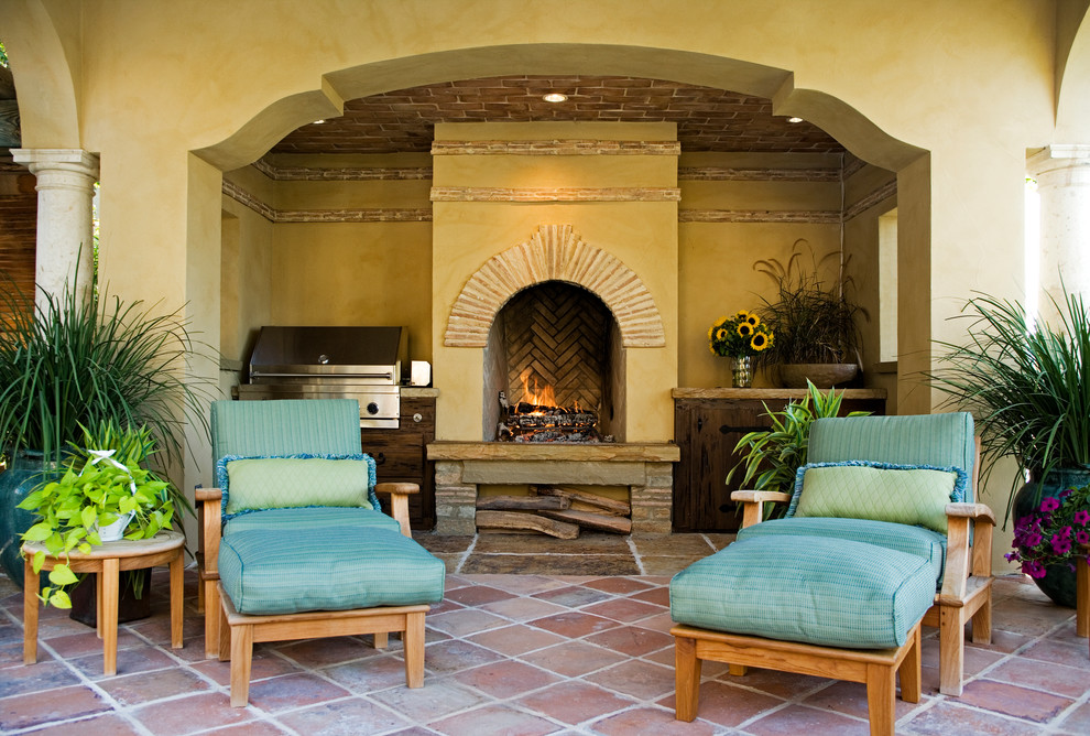 Example of a tuscan tile patio design in Other with a fire pit and a roof extension