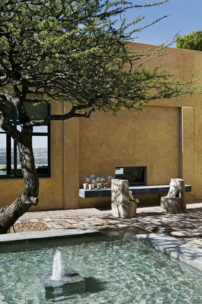 Inspiration for a mediterranean patio remodel in New York with a fire pit