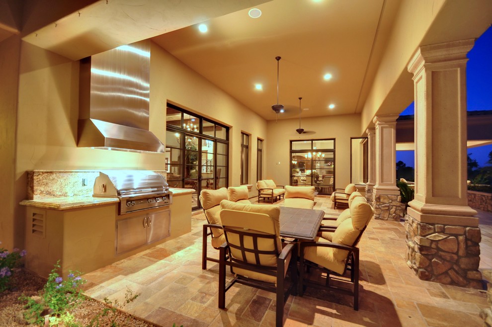 Inspiration for a mid-sized mediterranean backyard tile patio kitchen remodel in Phoenix with a roof extension