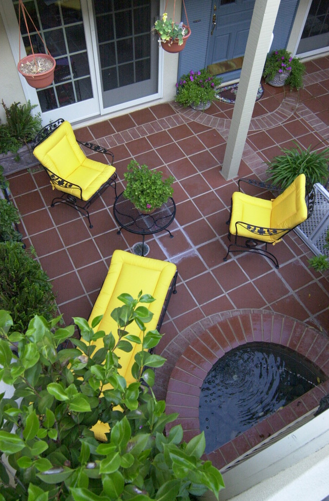 Patio fountain - small french country courtyard tile patio fountain idea in San Francisco with no cover
