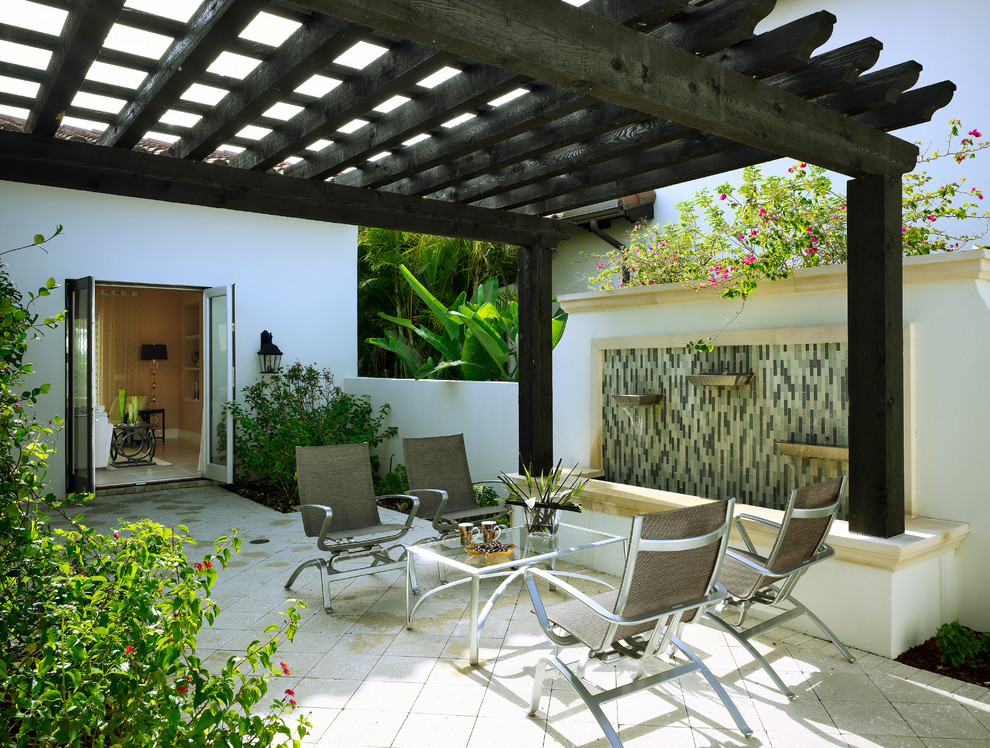 This is an example of a mediterranean patio in Other with a pergola.