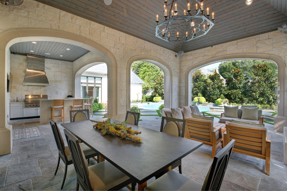 Mediterranean patio in Dallas with an outdoor kitchen and a roof extension.