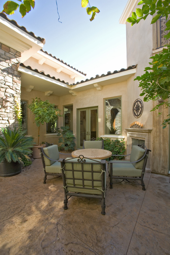 Design ideas for a mediterranean patio in Las Vegas with a fire feature, concrete slabs and no cover.