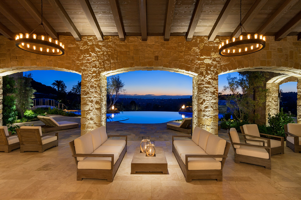 Inspiration for a mediterranean patio in San Diego with a roof extension.