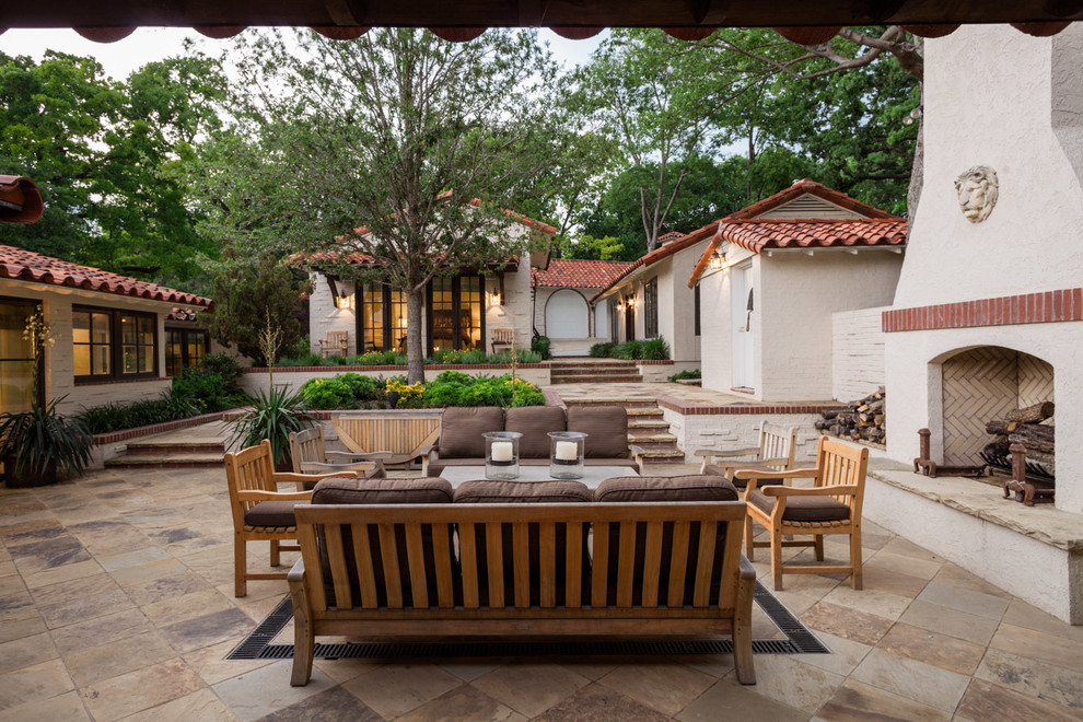 Mediterranean courtyard patio in Dallas with a fire feature.