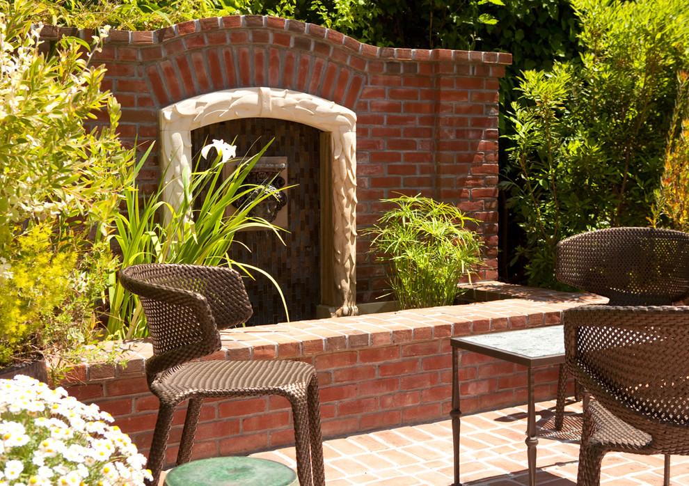 Inspiration for a mid-sized timeless side yard brick patio fountain remodel in San Francisco with no cover