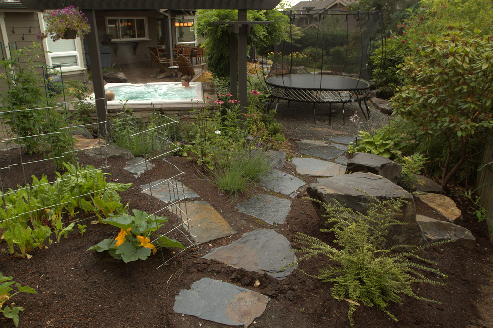 Inspiration for a large timeless backyard stone patio remodel in Seattle with a gazebo