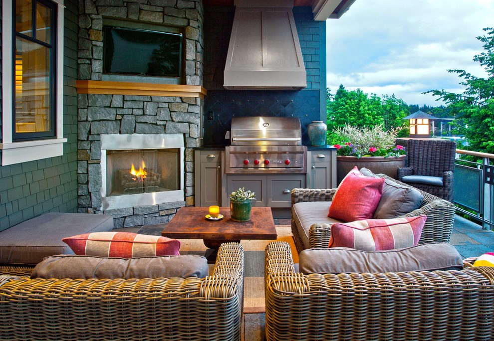 Example of a mid-sized classic backyard stone patio design in Seattle with a fire pit and a roof extension